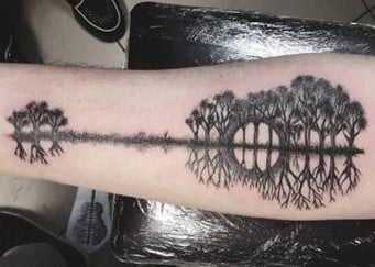 Guitar tatt trees and lake reflection tattoo