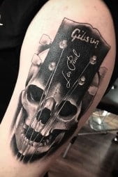 Skull base with guitar strings tattoo